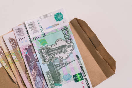 Russian money and envelope isolated on white background. Informal salary payment concept.の写真素材