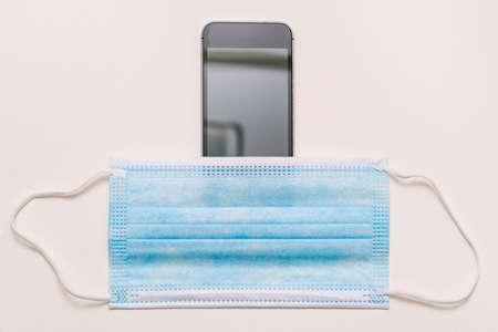 Mobile phone and disposable medical mask.の写真素材