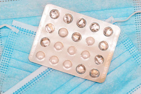 Silver packaging with pills and disposable medical masks. Medicine and healthcare, backgroundの写真素材