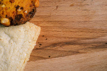 Rectangular and round baking on a wooden surface. Delicious homemade cakes. Food background with copy space.の写真素材