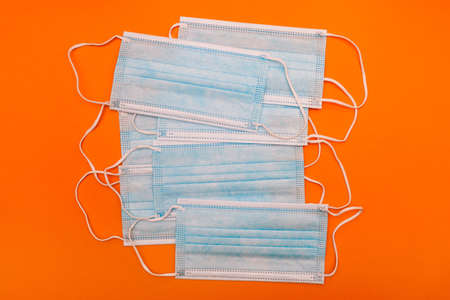 Many medical masks on a colored background. Surgical blue masks. Respiratory protection.の写真素材
