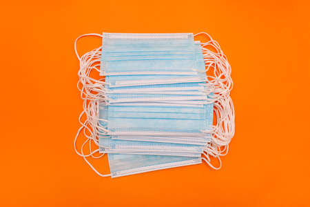 Face masks with ear loops. Three-layer protective medical masks on a colored background.の写真素材