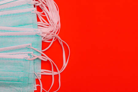 Medical face mask on colored background with copy space. Safety during a pandemic.の写真素材