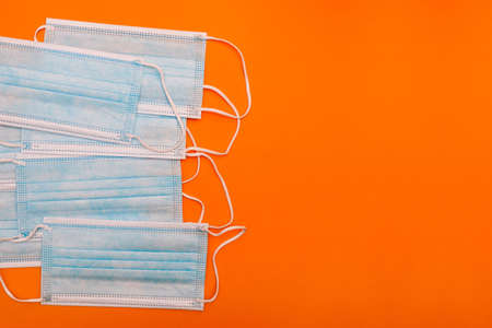 Many medical masks on a colored background. Surgical blue masks. Respiratory protection. Pandemic concept.の写真素材