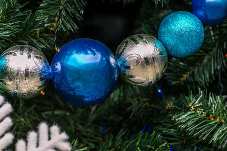 New Years round balls on the tree. Green spruce branches are decorated with toys. Christmas background. New year conceptの写真素材