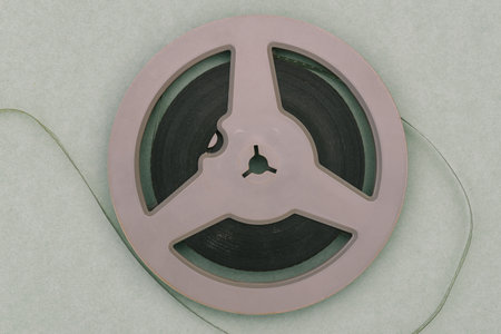 Round film reel. Gray bobbin close-up. The concept of watching an old movie. Family archive
