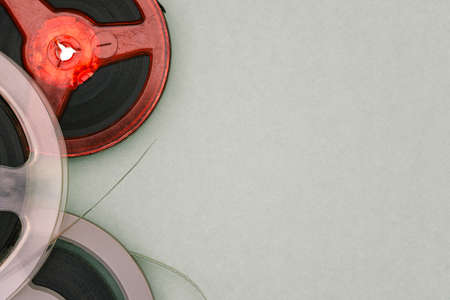 Old film reels on a green background with copy space. Magnetic tape. Top view, flat lay