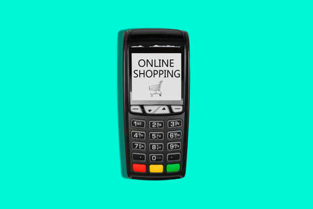 Payment terminal and shopping cart with the inscription Shopping online. E-commerce concept. Top view, flat layの写真素材