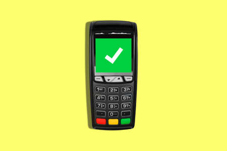 Pay for purchases with a mobile phone or credit card using a POS terminal. Successful and approved payment at the payment terminal. Transaction approval process. Top view, flat layの写真素材