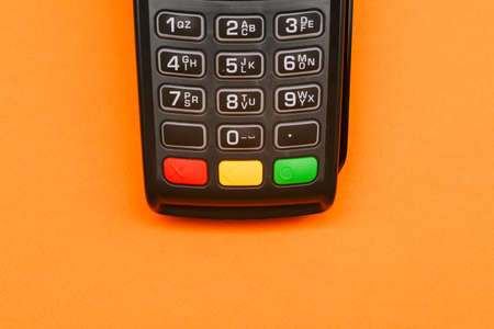 Modern payment terminal with copy space. Electronic device for accepting payment cards. Top view, flat layの写真素材