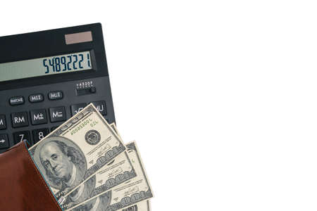 Money and calculator on a white background with copy space. Dollar bills in the wallet. Tax calculator. Budget planning. Payroll preparation. Finance and business conceptの写真素材