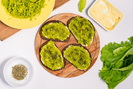 Avocado toast. Top view of sandwiches with avocado and salad on a wooden surface. Healthy homemade creamy toastの写真素材