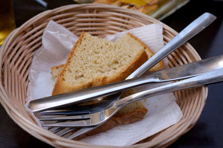 Bread basket with sliced bread, culery and white tissue の写真素材