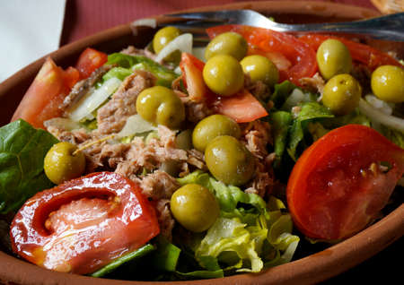 Salad with tomatoes, fresh lettuce, green olivesq, cheese and olive oil の写真素材