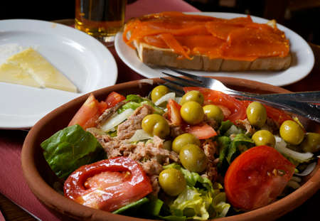 Plates with salad, salmon sandwich and goat cheese の写真素材
