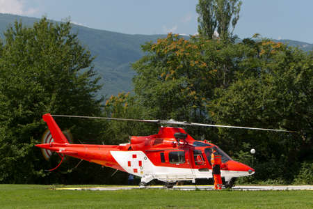 Red and white ambulance helicopter ready to takes offの写真素材