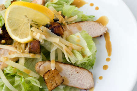 A Caesar Salad with shredded parmesan cheese, croutons and chicken の写真素材