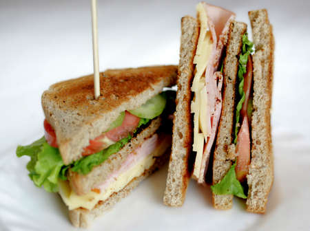 Toasted club sandwiches, tomato, meat and cheese.の写真素材