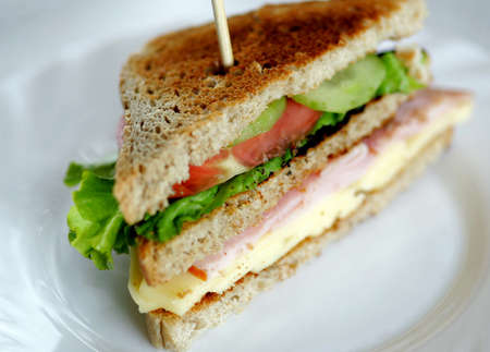 Toasted club sandwiches, tomato, meat and cheese.の写真素材