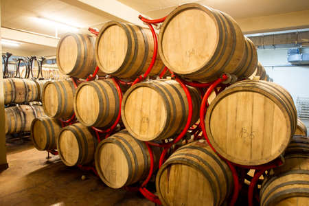 Wine barrels stacked in the old cellar of the winery, Bulgaria.の写真素材