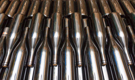 Dark cellar with bottles of red wine