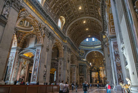 VATICAN CITY, VATICAN - APRIL 10: People are looking inside the basilica Saint Peter in Vatican on April 10, 2016 in Vatican City, Vatican.のeditorial素材