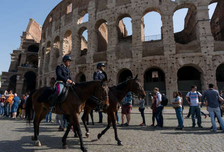 ROME, ITALY - APRIL 7: Colosseum was built in the first century AD by the Emperor Vespasian. Policemen on horses patrol near the Colosseum on April 7, 2016, Rome, Italy.のeditorial素材