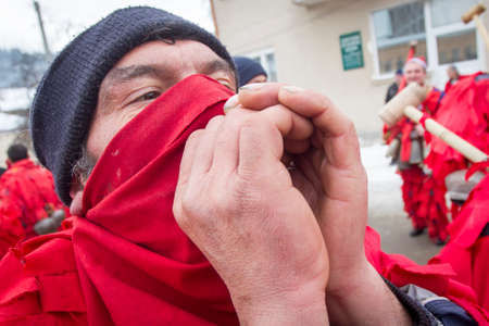 BREZNIK, BULGARIA - JANUARY 21, 2017: Masquerade player called "Kuker" is seen during customary games on January 21, 2017 in Breznik, Bulgaria.のeditorial素材