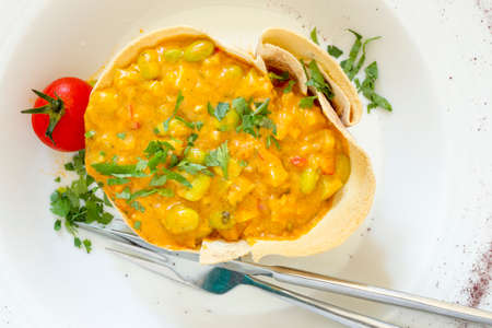 Soybean stew with vegetables and parsley.の写真素材