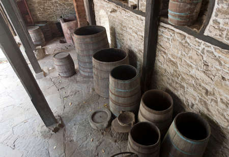 Open old wooden barrels in ancient cellar