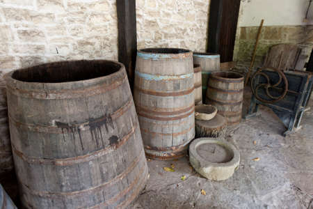 Open old wooden barrels in ancient cellarの写真素材