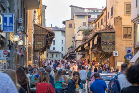 ITALY - FLORENCE - SEPTEMBER 4: Crowds of people are make their way through the pedestrian bridge Ponte Vecchio in Florence, Tuscany, Italy on September 4 2018.のeditorial素材