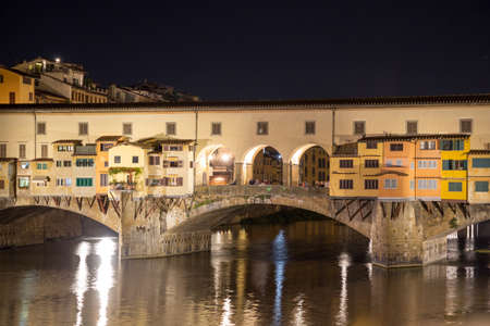 ITALY - FLORENCE - SEPTEMBER 4: River Arno and famous bridge Ponte Vecchio at night in Florence, Tuscany, Italy on September 4 2018.のeditorial素材