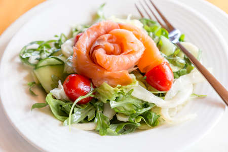 Salad mix with smoked salmon fillet and campari cherry tomatoes.の写真素材