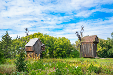 Old wooden windmills looking to a forest. Pereyaslav, Ukraine.のeditorial素材