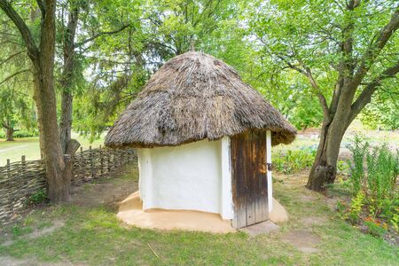 An old straw-roof cellar entry at fall. Pereyaslav Khmelnitskiy, Ukraine.の写真素材