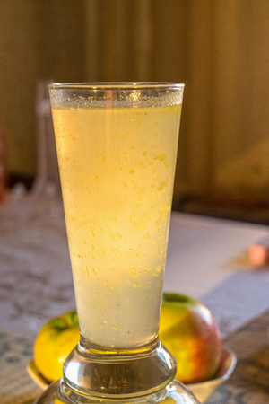 A glass of natural chicken bouillon with frozen orbs of fat.の写真素材