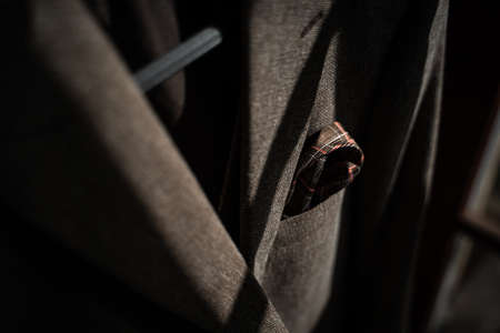A close up of a person wearing a suit and tie