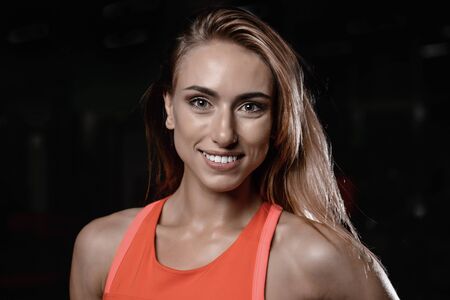 Beautiful woman face close up portrait young studio on grayの写真素材