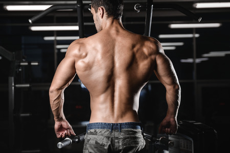 man with weight training in gym equipment sport club