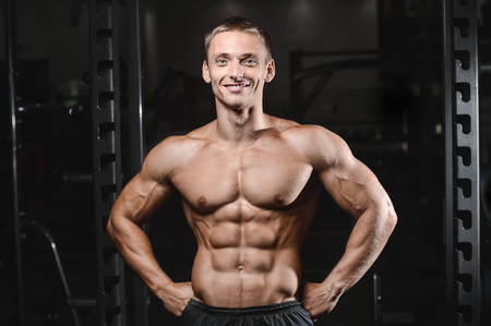 young man train in the gym healthcare lifestyle sexy caucasian man bodybuilder work out naked body torsoの写真素材