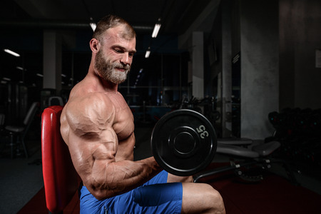 brutal muscular man with beard train in the gym unshaven fitness model healthcare lifestyle with topless body strong absの写真素材