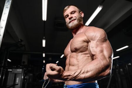 brutal muscular man with beard train in the gym unshaven fitness model healthcare lifestyle with topless body strong absの写真素材