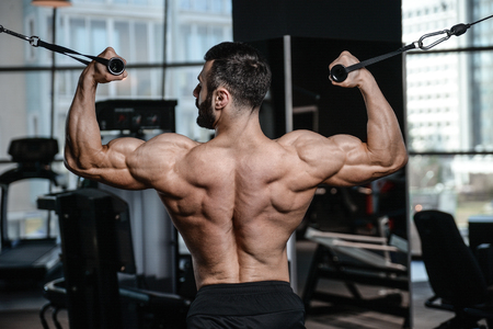 Fitness instructor handsome man in the gym gain muscle healthcare lifestyle sexy caucasian man bodybuilder work out naked body with tattooの写真素材