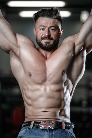 Brutal strong athletic men pumping up muscles and train in gym workout bodybuilding concept...