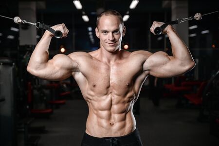 young man train in the gym healthcare lifestyle sexy caucasian man bodybuilder work out naked body...