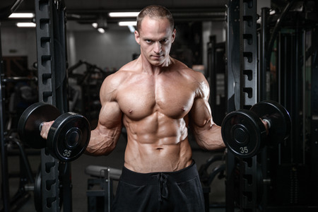 young man train in the gym healthcare lifestyle sexy caucasian man bodybuilder work out naked body torso diet in joyの写真素材