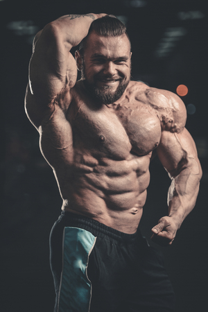 Handsome caucasian sexy fitness model in gym close up abs concept man on diet shirtless training six pack healthcare lifestyle crunchの写真素材
