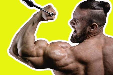 Handsome power athletic man on diet training pumping up muscles with dumbbell and barbell. Strong bodybuilder with six pack, perfect abs, shoulders, biceps, triceps and chestの写真素材