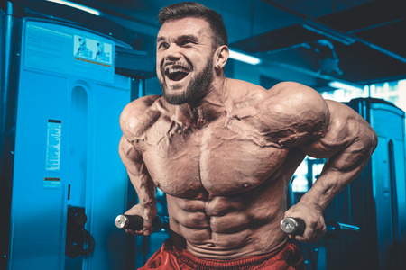 Brutal caucasian handsome fitness men on diet training chest pumping up bodyの写真素材